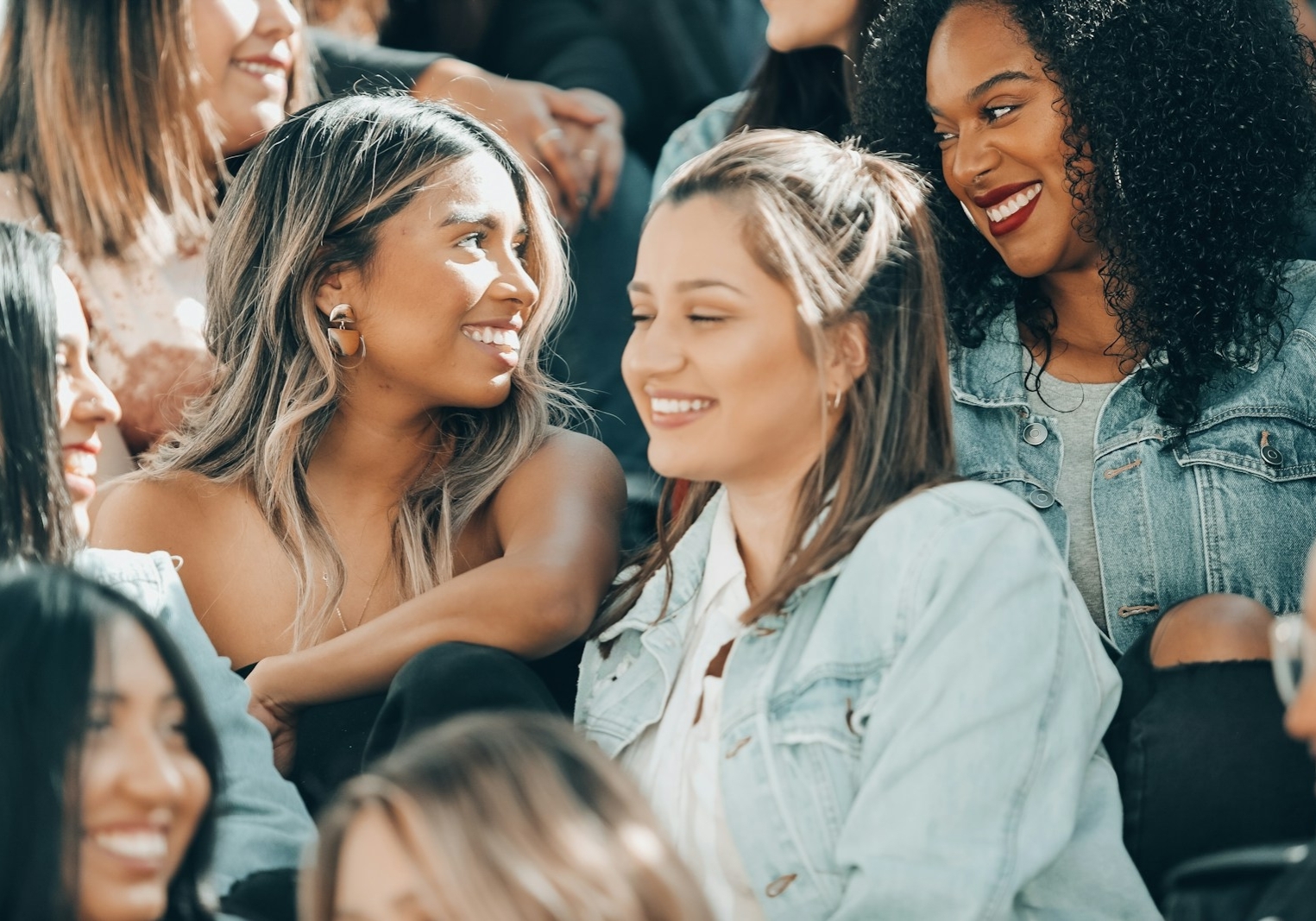 woman in white button up shirt beside woman in black tank top